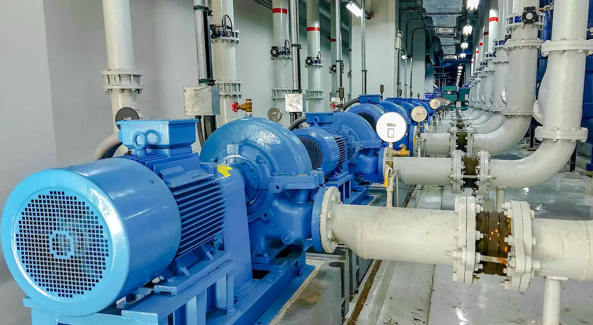 SEQ Pumps professional inspecting a pump system for quality control.